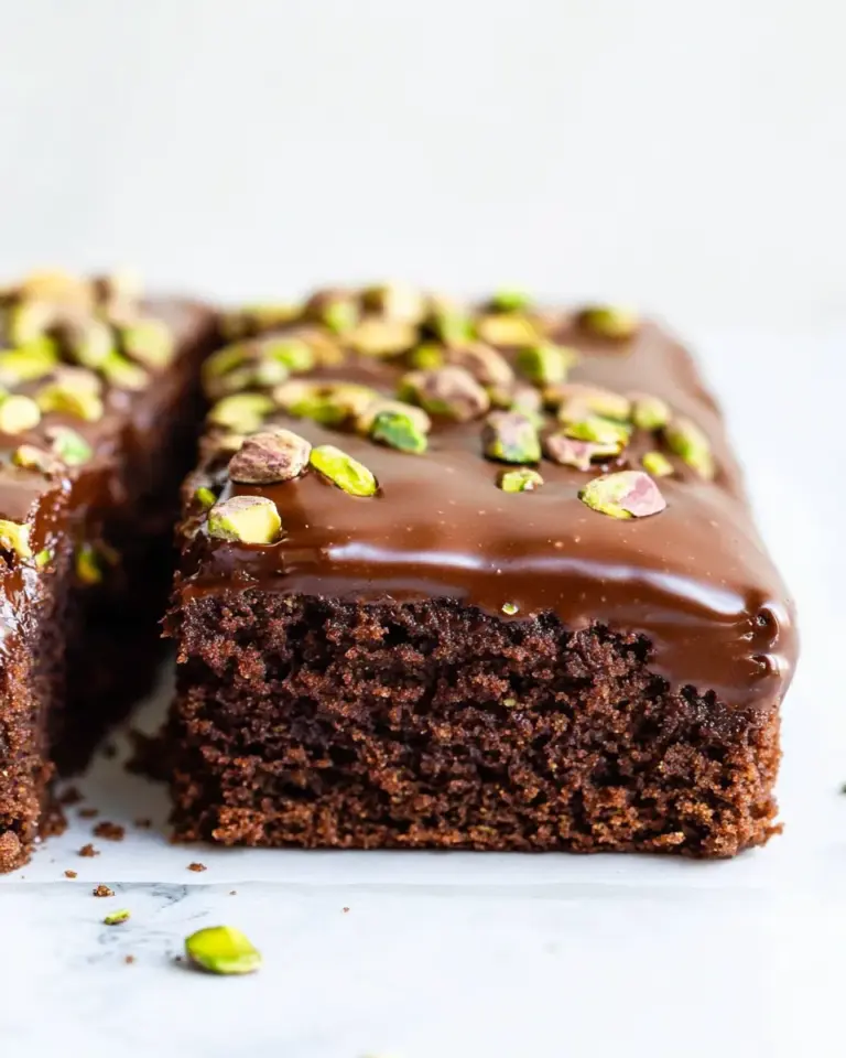Homemade Whole Wheat Chocolate Fudge Zucchini Snack Cake with Candied Pistachios. photo